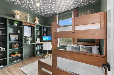a bedroom with two bunk beds and a desk at Avocado Akres Awaits Near Monserate Winery in Fallbrook
