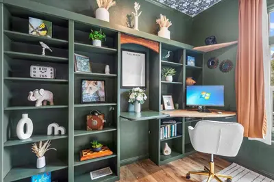 a home office with green walls and a desk with a computer at Avocado Akres Awaits Near Monserate Winery in Fallbrook
