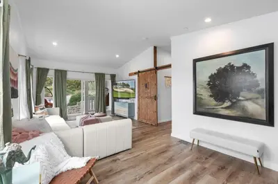 a living room with a large painting on the wall at Avocado Akres Awaits Near Monserate Winery in Fallbrook
