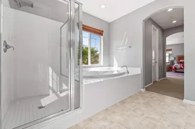 a bathroom with a glass shower and a tub at 430 Large home sleeps 10 in Fallbrook