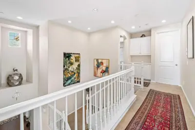 a white staircase in a home with a red rug at 430 Large home sleeps 10 in Fallbrook