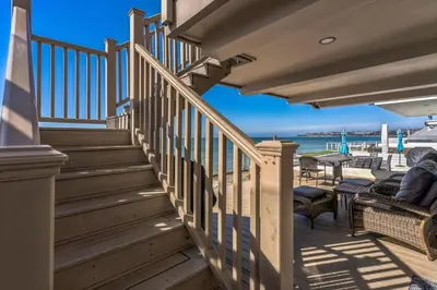 a staircase leading to a deck with a view of the ocean at 450A Ocean View beach house in Dana Point