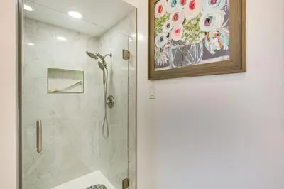 a bathroom with a shower and a painting on the wall at 474 Oasis w Amazing Views Huge Pool in La Mesa