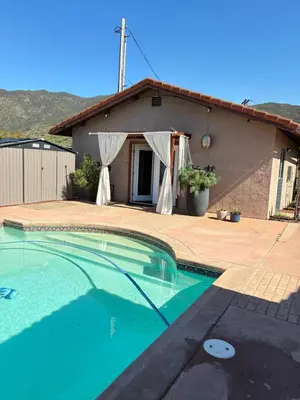 a swimming pool in front of a house at Painted sky casita in San Diego