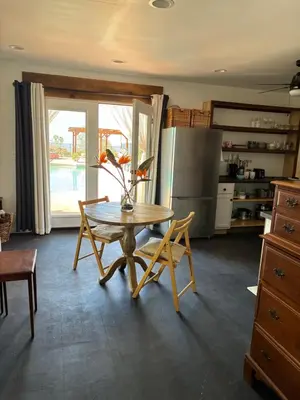 a kitchen with a table and chairs and a refrigerator at Painted sky casita in San Diego