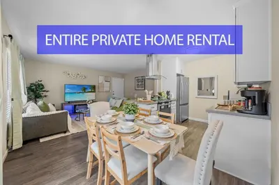 a kitchen and living room with a table and chairs at Entire Private Home with 2 Bedrooms 1 Bathroom, King Bed, Pool, Hot Tub, 2 Parking in Mira Mesa Available Now in San Diego