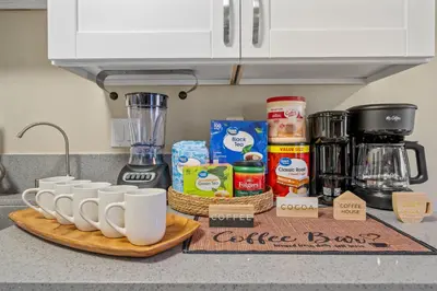 a counter with a bunch of coffee cups on a cutting board at Entire Private Home with 2 Bedrooms 1 Bathroom, King Bed, Pool, Hot Tub, 2 Parking in Mira Mesa Available Now in San Diego