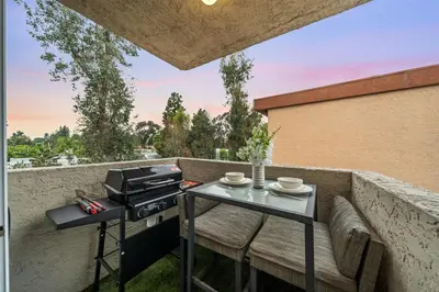 a patio with a grill and a table and chairs at Entire Private Home with 2 Bedrooms 1 Bathroom, King Bed, Pool, Hot Tub, 2 Parking in Mira Mesa Available Now in San Diego
