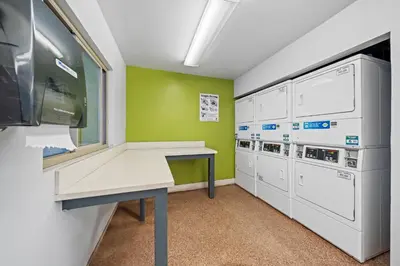a laundry room with a desk and washer and dryer at Entire Private Home with 2 Bedrooms 1 Bathroom, King Bed, Pool, Hot Tub, 2 Parking in Mira Mesa Available Now in San Diego