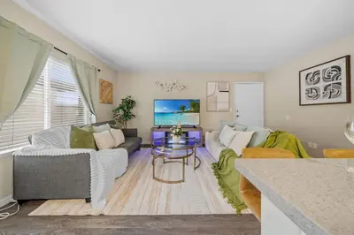 a living room with a couch and a table at Entire Private Home with 2 Bedrooms 1 Bathroom, King Bed, Pool, Hot Tub, 2 Parking in Mira Mesa Available Now in San Diego
