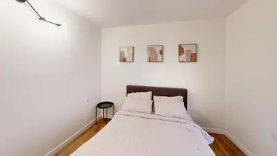 a white bedroom with a bed with two pillows at Spacious 4BR Loft - Outdoor Movie Theater in El Cajon