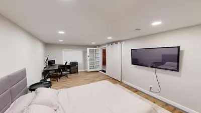 a living room with a television on a wall at Spacious 4BR Loft - Outdoor Movie Theater in El Cajon