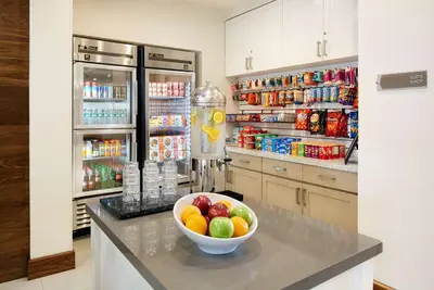 a kitchen with a bowl of fruit on a counter at Homewood Suites by Hilton Aliso Viejo Laguna Beach in Aliso Viejo