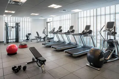 a gym with a lot of treadmills and machines at Homewood Suites by Hilton Aliso Viejo Laguna Beach in Aliso Viejo