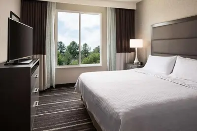 a hotel room with a bed and a large window at Homewood Suites by Hilton Aliso Viejo Laguna Beach in Aliso Viejo