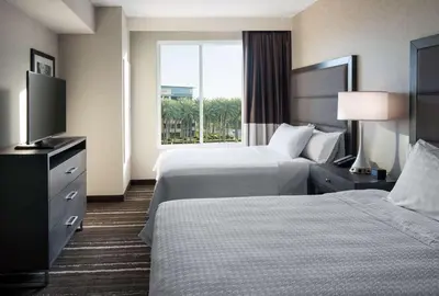 a hotel room with two beds and a window at Homewood Suites by Hilton Aliso Viejo Laguna Beach in Aliso Viejo