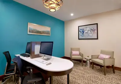 an office with a desk with a computer and chairs at Homewood Suites by Hilton Aliso Viejo Laguna Beach in Aliso Viejo