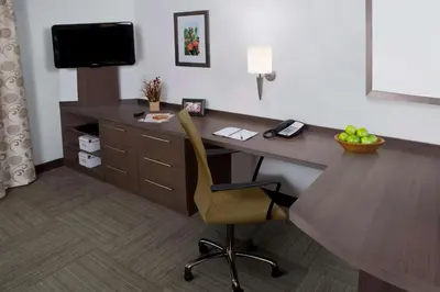a hotel room with a desk and a chair at Sonesta Simply Suites Irvine Spectrum in Irvine