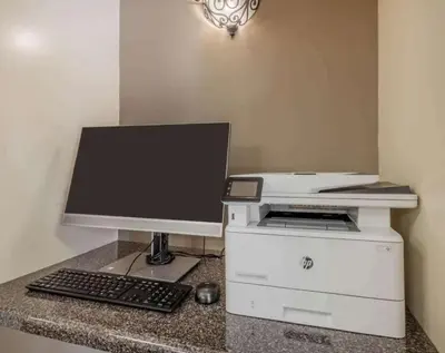 a computer monitor and a printer on a counter at Sonesta Simply Suites Irvine Spectrum in Irvine