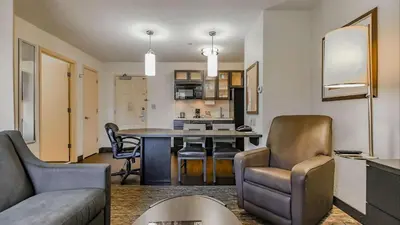 a living room and kitchen with a table and chairs at Sonesta Simply Suites Irvine Spectrum in Irvine