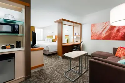 a hotel room with a bed and a couch at SpringHill Suites by Marriott San Diego Mission Valley in San Diego