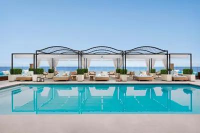 a swimming pool with couches and a pavilion at Surf & Sand Laguna Beach in Laguna Beach