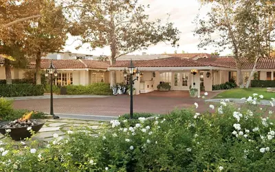 a building with a courtyard with flowers and trees at Rancho Bernardo Inn in Rancho Bernardo