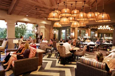 a lobby of a restaurant with people sitting in chairs at Rancho Bernardo Inn in Rancho Bernardo