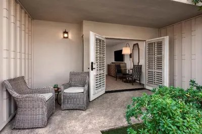 a porch with wicker chairs and a living room at Rancho Bernardo Inn in Rancho Bernardo