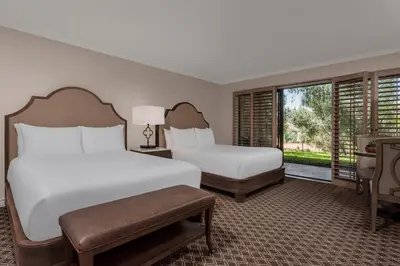 a hotel room with two beds and a window at Rancho Bernardo Inn in Rancho Bernardo