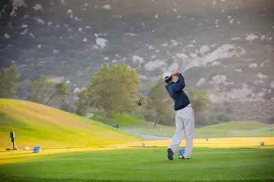 a man swinging a golf club on a golf course at Temecula Creek Inn in Temecula
