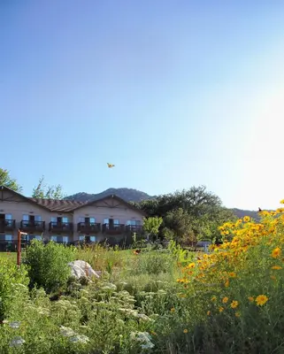 a garden with flowers in front of a building at Temecula Creek Inn in Temecula