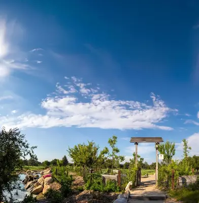 a person walking down a path next to a river at Temecula Creek Inn in Temecula