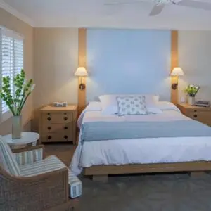 a bedroom with a large bed and a chair at Scripps Inn in San Diego