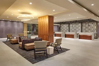 a lobby with a waiting area with chairs and tables at Homewood Suites by Hilton San Diego Downtown/Bayside in San Diego