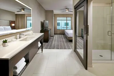 a hotel bathroom with two sinks and a shower at Homewood Suites by Hilton San Diego Downtown/Bayside in San Diego