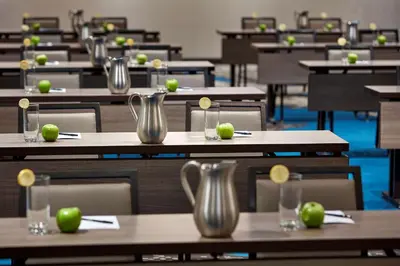 an empty classroom with tables with green apples on them at Homewood Suites by Hilton San Diego Downtown/Bayside in San Diego