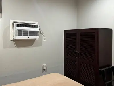 a bedroom with a air conditioner on a wall at Rodeway Inn El Cajon - San Diego East in El Cajon