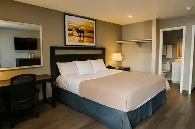 a hotel room with a bed and a desk and a bedroom at Rodeway Inn El Cajon - San Diego East in El Cajon