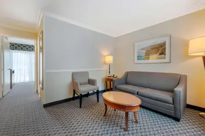 a living room with a couch and a table at Best Western Plus Marina Shores Hotel in Dana Point