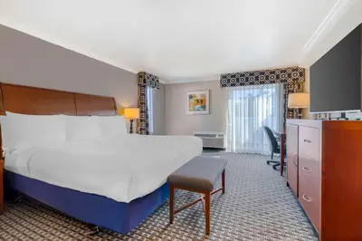 a bedroom with a bed and a desk and a chair at Best Western Plus Marina Shores Hotel in Dana Point