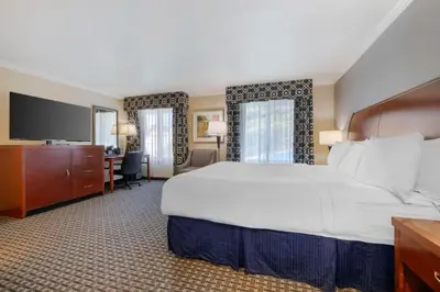 a hotel room with a large bed and a desk at Best Western Plus Marina Shores Hotel in Dana Point