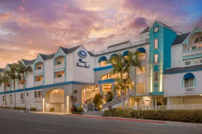 a hotel with palm trees in front of a building at Best Western Plus Marina Shores Hotel in Dana Point