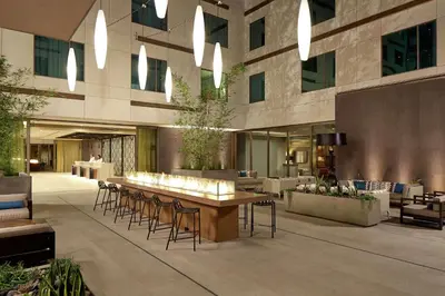 a lobby of a building with a table and chairs at Hilton Garden Inn San Diego Downtown/Bayside, CA in San Diego