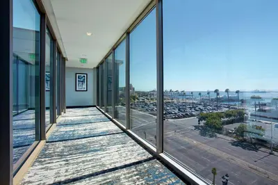 an office building with large windows and a view of a parking lot at Hilton Garden Inn San Diego Downtown/Bayside, CA in San Diego