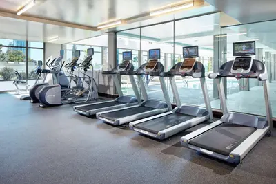 a gym with a row of treadmills and ellipticals at Hilton Garden Inn San Diego Downtown/Bayside, CA in San Diego