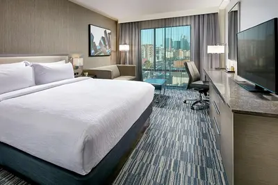 a hotel room with a bed and a flat screen tv at Hilton Garden Inn San Diego Downtown/Bayside, CA in San Diego