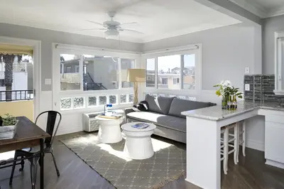 a living room with a couch and a table at Newport Beach Hotel in Newport Beach