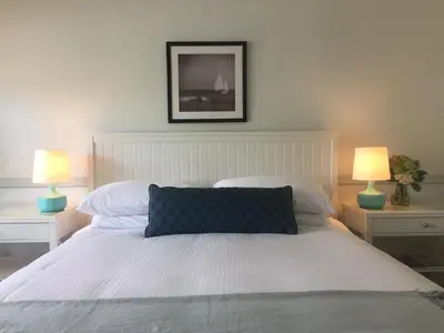 a bedroom with a white bed with two lamps at Blue Lantern Inn, A Four Sisters Inn in Dana Point