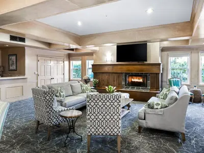 a living room with a couch and a fireplace at Blue Lantern Inn, A Four Sisters Inn in Dana Point